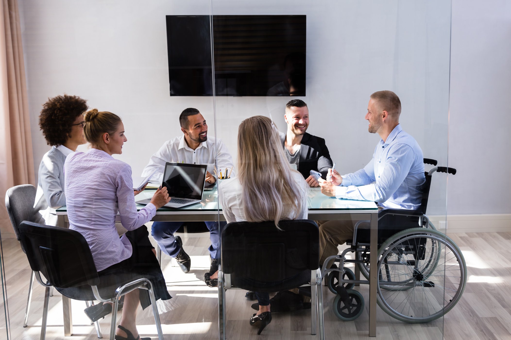 Disabled Manager Sitting With His Colleagues